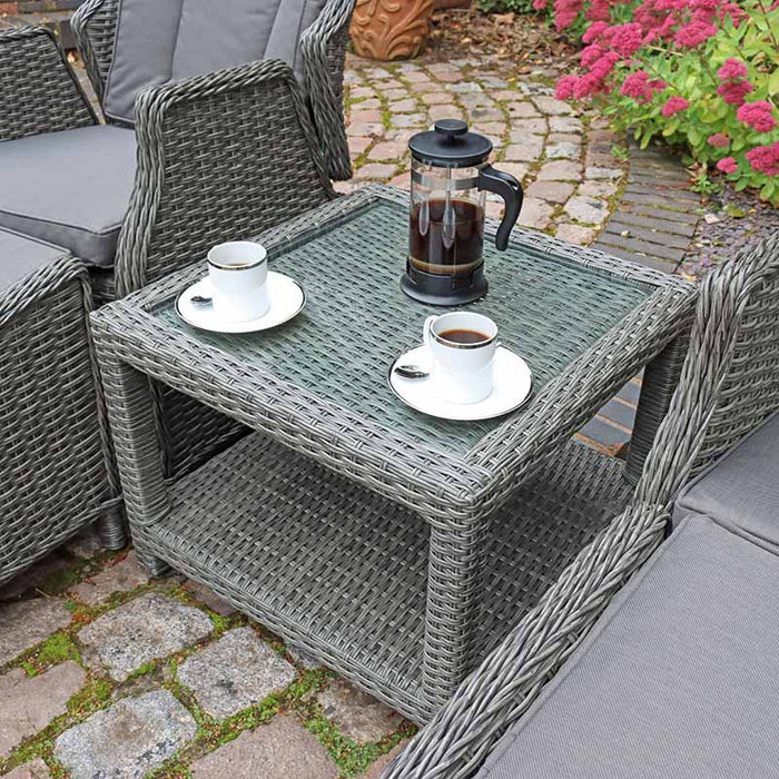 A close-up of the Paris Recliner Set’s glass-top side table, featuring a coffee setup, adding a cosy and inviting touch to the seating arrangement.