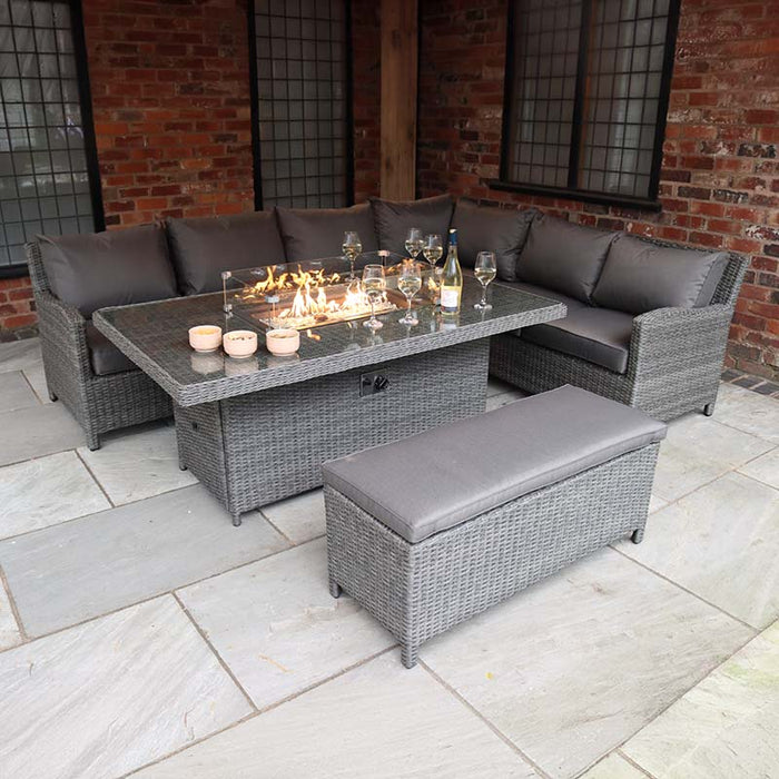 Elegant setup of the Paris Fire Pit Corner Dining & Lounge Set with a rectangular table outdoors, featuring cosy grey cushions and fire pit table, perfect for alfresco dining.