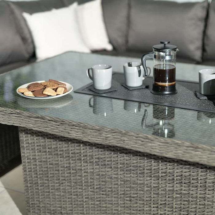 A close-up of the Paris Fire Pit Corner Dining & Lounge Set’s table, featuring a coffee set and a plate of biscuits, perfect for a relaxing moment.