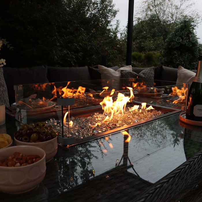 A close-up of the Paris Fire Pit Corner Dining & Lounge Set’s fire pit, with flames dancing over glass crystals, creating a warm and inviting atmosphere.