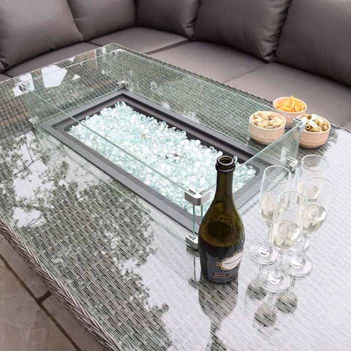 A top-down view of the Paris Fire Pit Corner Dining & Lounge Set’s rectangular table, capturing the fire pit surrounded by glassware and snacks, perfectly complementing the comfortable seating.