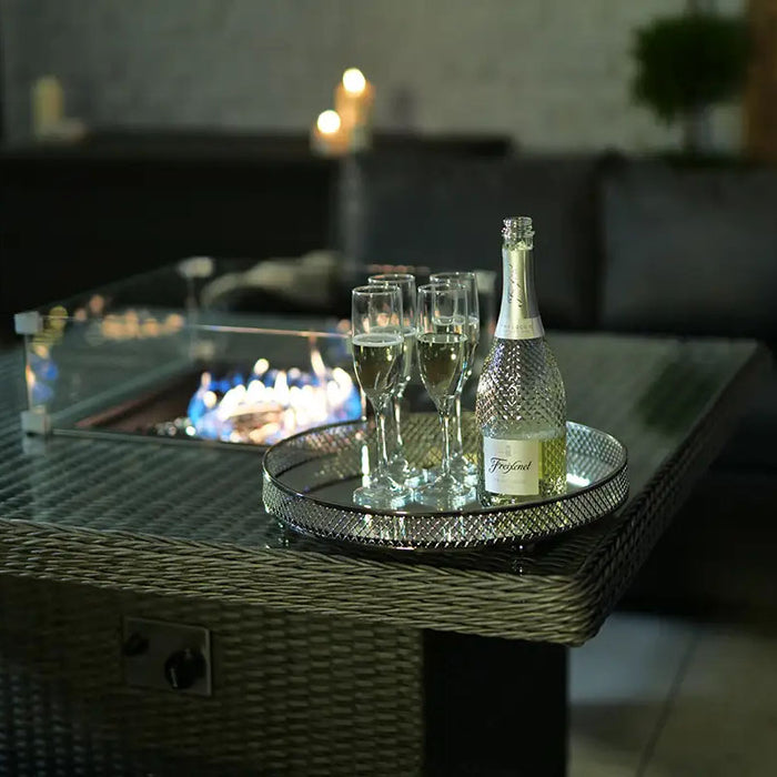 Champagne and glasses elegantly displayed on the square table of the Paris Fire Pit Lounge Set, perfect for entertaining.