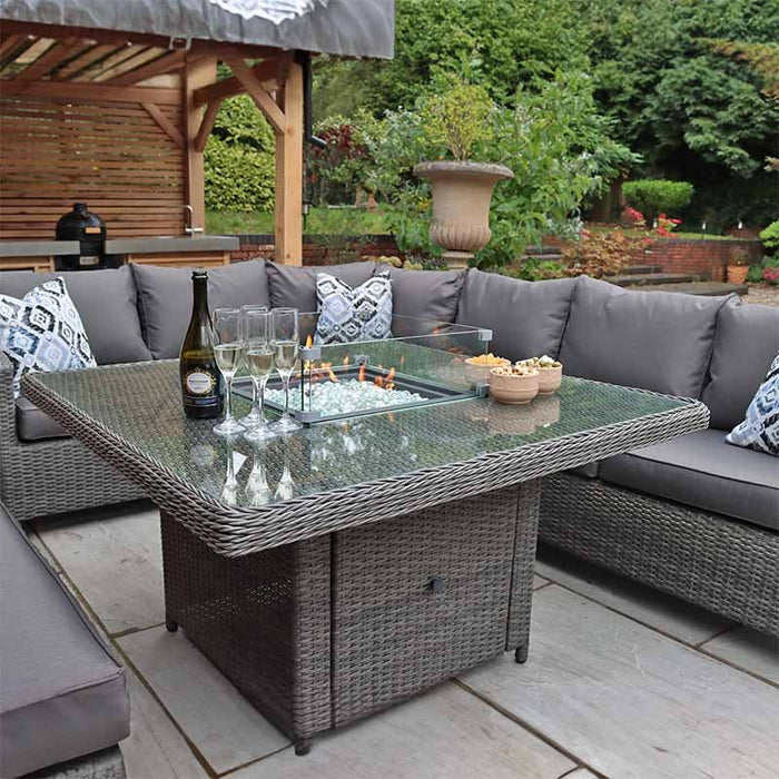 Focus on the stylish fire pit feature of the Paris Corner Dining Set, with glass screen and cosy setup.