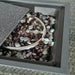 Close-up of the decorative stones within the fire pit of the Paris Fire Pit Lounge Set, adding a touch of elegance.