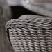 A detailed close-up of the Paris Imperial Round Dining Set's woven rattan armrest, showcasing the intricate craftsmanship and luxurious design.