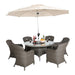 Elegant Paris Imperial Round Dining Set arranged under a beige parasol, perfect for outdoor meals and gatherings.