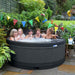  Group enjoying a garden party in a round outdoor hot tub