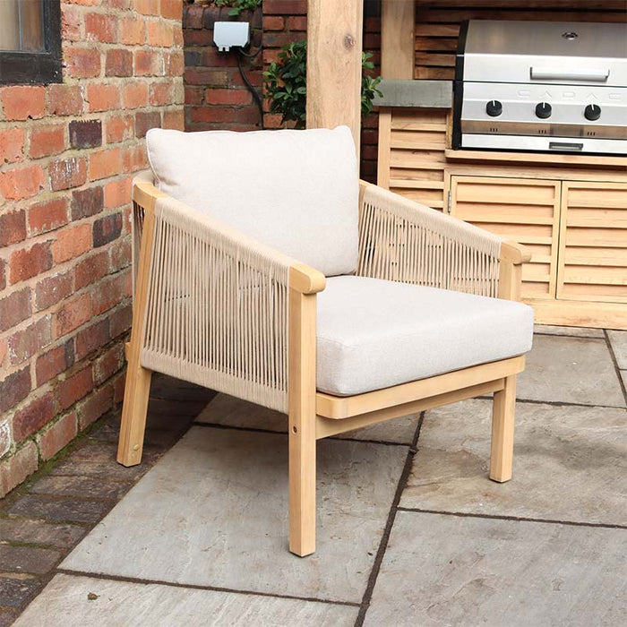 Roma 4 Seater Double Lounge Set chair placed in a garden environment, featuring an acacia wood frame, woven rope design, and soft grey cushions, ideal for luxurious outdoor seating arrangements.