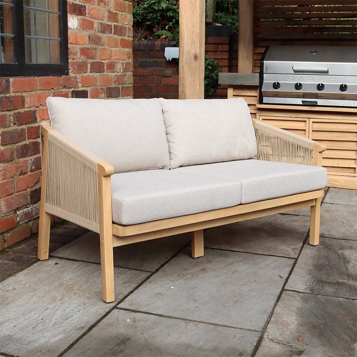 The Roma 2-seater sofa, part of the Roma 4 Seater Double Lounge Set, with a robust acacia wood frame, elegant woven rope sides, and light grey cushions, perfect for enhancing your garden seating area.