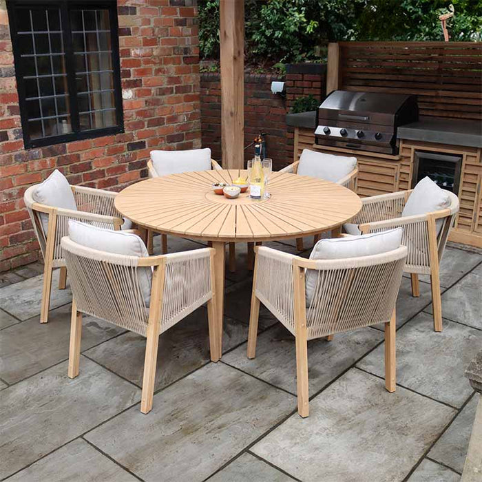 The Roma 6 Seater Dining Set with Deluxe Rope Chairs, featuring a round wooden table and outdoor rope chairs, arranged on a stylish patio for a modern outdoor dining experience.