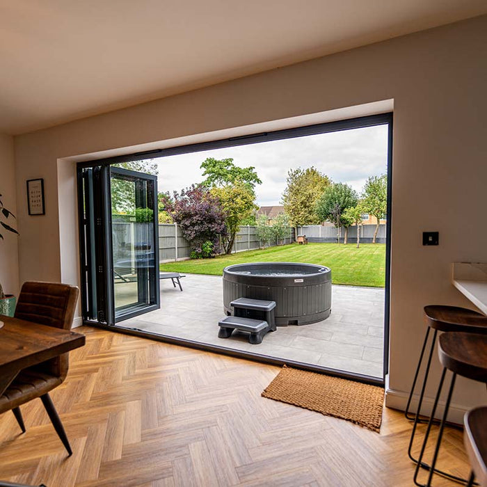 Indoor-outdoor view of Rotospa Orbis Hot Tub offering a luxury spa experience at home.