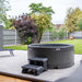 Rotospa Orbis Hot Tub placed in a contemporary garden patio for luxury home living.