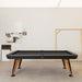RS Barcelona Diagonal outdoor pool table in black finish with wooden legs, contemporary billiard table in minimalist studio interior setting.