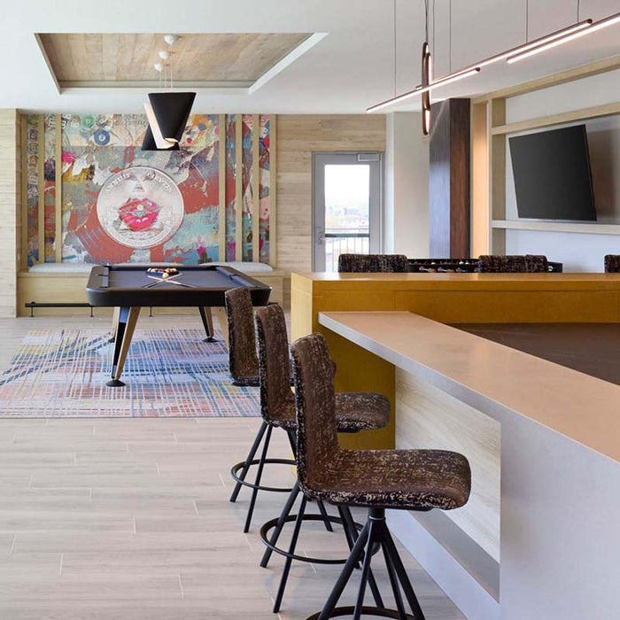 RS Barcelona Diagonal outdoor pool table in designer entertainment space with bar seating, modern billiards table in luxury interior setting.