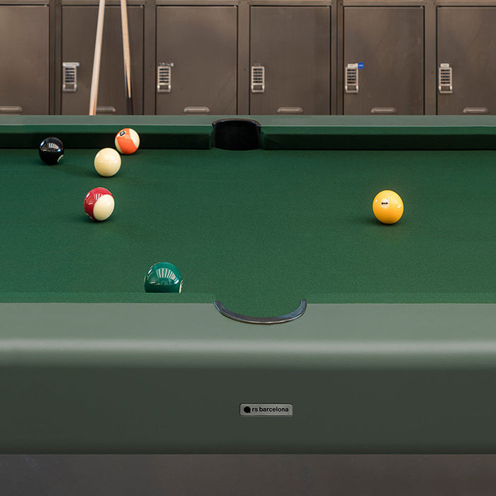 Close-up of RS Barcelona Diagonal outdoor pool table in green with billiard balls near pocket, detailed felt surface and branding plate.