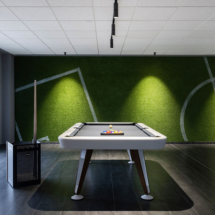 RS Barcelona Diagonal outdoor pool table in white with wooden legs in modern games room with green wall, stylish billiard table setting.