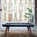 RS Barcelona Diagonal pool table with black frame and wooden legs placed by large windows in a modern interior space.