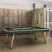 RS Barcelona Diagonal pool table in green finish with wooden legs placed in an industrial style game room with lockers.