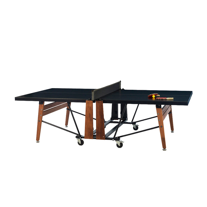 RS Barcelona folding ping pong table in covered outdoor setting with black tabletop, wooden legs, net and wheeled frame for versatile indoor outdoor use.