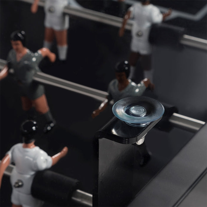 Close-up of RS Barcelona RS MAX dining football table glass top corner detail with foosball players visible beneath the surface.