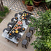 High angle view of RS Barcelona RS Max dining football table in lush outdoor garden, glass tabletop with full dining setup, multifunctional foosball dining table for entertaining spaces.