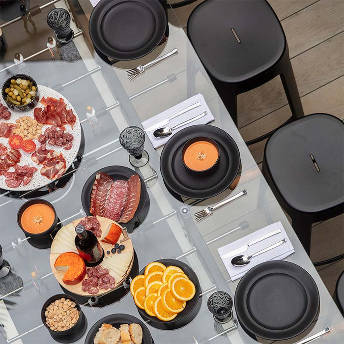 Top view of RS Barcelona RS Max dining football table with glass tabletop, elegant place settings and gourmet food display, multifunctional foosball dining table for stylish entertaining.