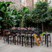 RS Barcelona RS MAX outdoor dining football table surrounded by stools and set with food and drinks for garden entertaining.