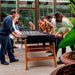 Players gathered around the RS Barcelona RS MAX football table enjoying a competitive game on a premium outdoor designer foosball table.