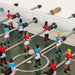 Close-up detail of RS Barcelona RS2 dining football table players and rods, premium designer foosball table with glass dining top and modern football figures.