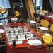 RS Barcelona RS2 dining football table in red used as a restaurant dining table with glass surface, set with plates and wine glasses, combining foosball game and dining furniture.