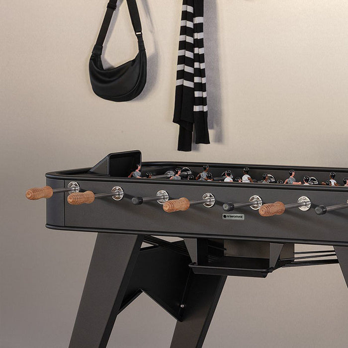 Detail view of RS Barcelona RS2 football table with wooden handles, stainless steel rods and modern black frame.