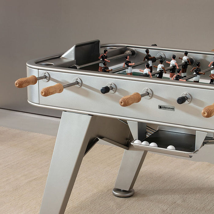 Angled view of RS Barcelona RS2 football table in grey with stainless steel rods and wooden handles.