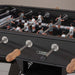 Detailed view of RS Barcelona RS2 football table player figures on the pitch showing classic foosball gameplay design.