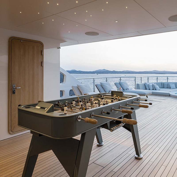 RS Barcelona RS2 football table placed on a luxury yacht deck overlooking the sea, showcasing a premium outdoor foosball table.
