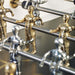 Close-up of RS Barcelona RS2 Gold football table player figures in gold and silver on stainless steel rods, showcasing premium foosball table craftsmanship.