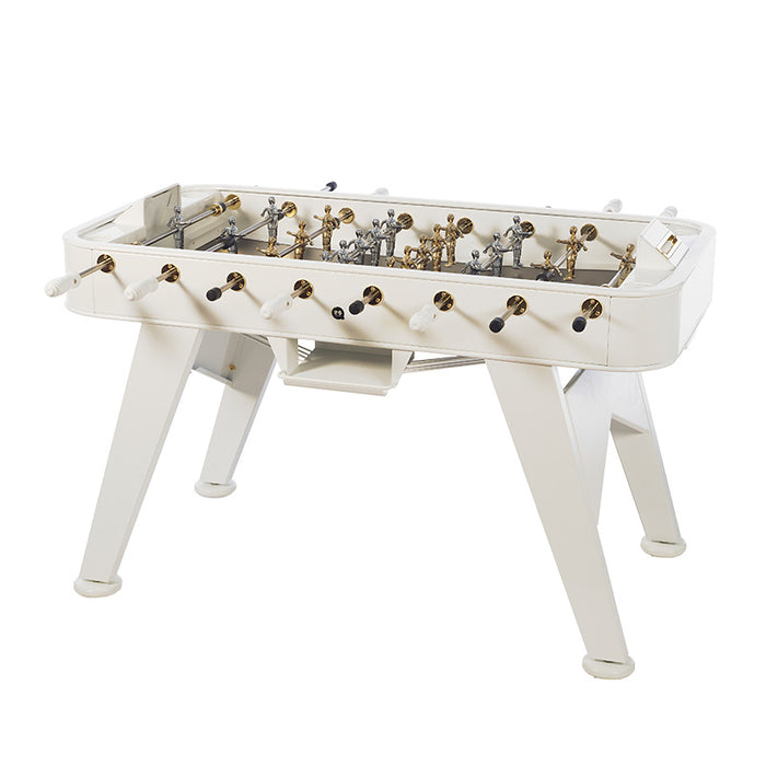 Angled view of the RS Barcelona RS2 Gold football table in white with gold accents, a luxury designer foosball table for home and commercial spaces.