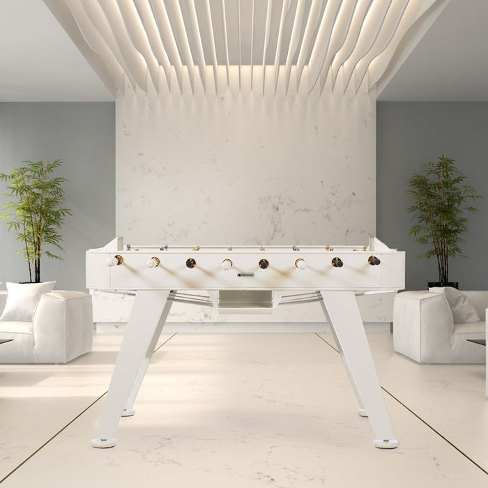 RS Barcelona RS2 Gold football table in white finish styled in a modern interior space, luxury designer foosball table for contemporary game rooms.