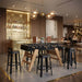 RS Barcelona RS3 dining football table with glass tabletop styled in a modern bar interior with stools, combining foosball table gameplay with contemporary dining furniture.