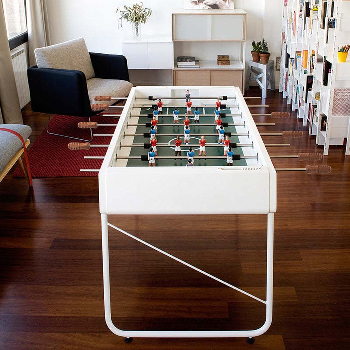 RS Barcelona RS3 white football table with wooden handles in a stylish living room, modern designer foosball table ready for play.