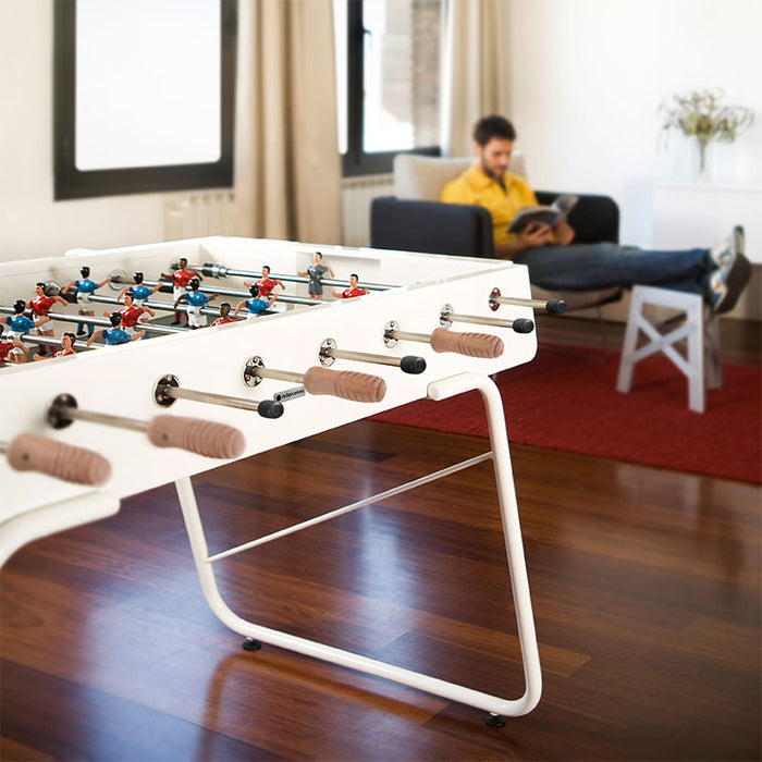RS Barcelona RS3 football table in contemporary living room with white frame and wooden handles, stylish indoor foosball table with relaxed home setting and modern décor.