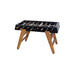 RS Barcelona RS3 Wood football table in black with solid wooden legs and steel rods, modern designer foosball table shown in a clean studio product setting.