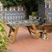 RS Barcelona RS3 Wood football table in rustic garden patio with decorative tiles and greenery, stylish outdoor foosball table with wooden legs and contemporary design.