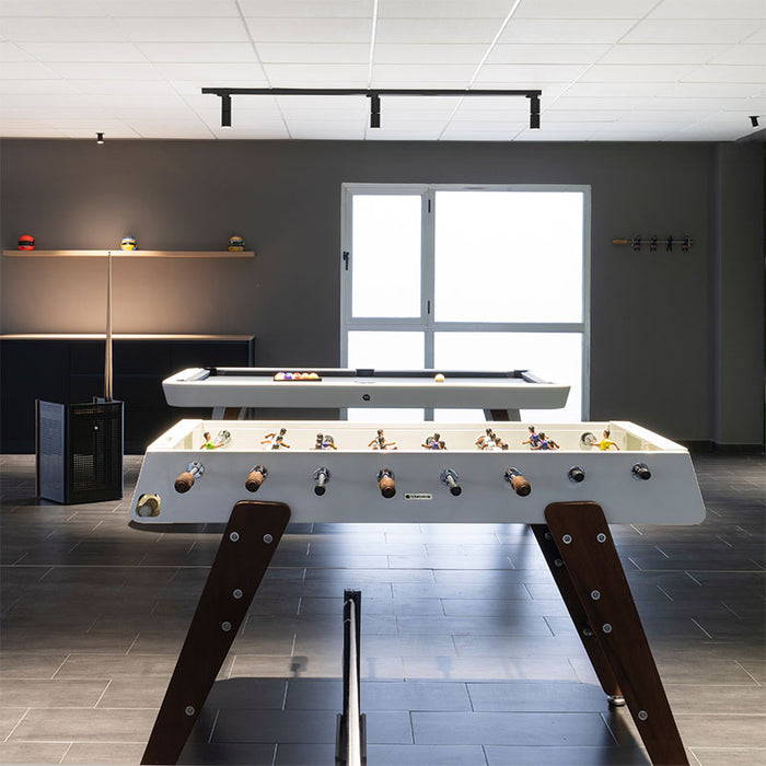 RS Barcelona RS3 Wood football table in modern indoor game room with sleek lighting and open space, contemporary foosball table design for leisure and entertainment.