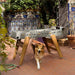 RS Barcelona RS3 Wood football table in outdoor courtyard with dog walking past, durable outdoor foosball table with wooden legs and modern neutral finish.