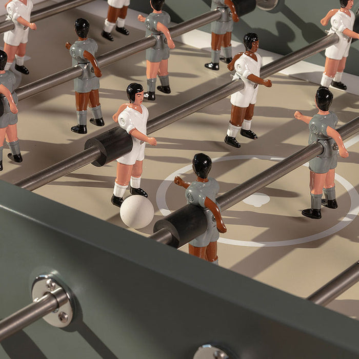 Detailed view of RS Barcelona RS3 Wood football table player figures on a minimalist grey pitch with precision rods and modern foosball design.