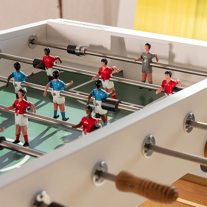 Close-up of RS Barcelona RS3 Wood football table players and rods, detailed foosball figures on green pitch with wooden handles, premium indoor game table design.