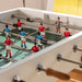 Close-up of RS Barcelona RS3 Wood football table players and rods, detailed foosball figures on green pitch with wooden handles, premium indoor game table design.