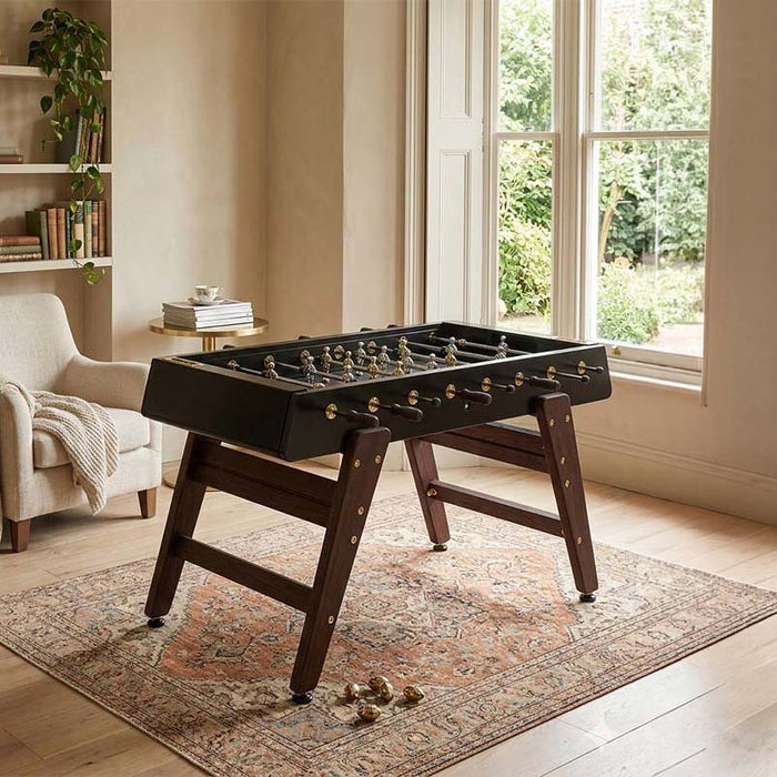 RS Barcelona RS3 Wood Gold football table styled in a contemporary living space with wooden flooring and modern interior design.