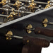 Side detail of RS Barcelona RS3 Wood Gold football table featuring carved wooden handles, polished rods and brass mounting plates on a premium foosball table.