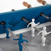 Close-up of RS Barcelona RS4 Home football table players in blue and white, detailed foosball figures on metal rods with wooden handles, modern indoor game table craftsmanship.